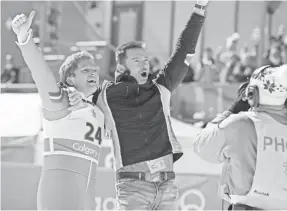  ?? LARRY HORRICKS ?? British ski jumper Eddie (Taron Egerton, left) and his coach (Hugh Jackman) fly high even in defeat in “Eddie the Eagle.”