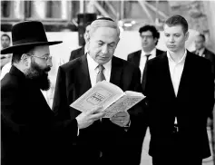  ??  ?? File photo shows Netanyahu (centre) reading a prayer with Western Wall Rabbi Shmuel Rabinowitz as his son Yair (right) stands next to him, at the Western Wall, Judaism’s holiest prayer site, in Jerusalem’s Old City. — Reuters photo