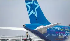  ?? BRENT LEWIN/ BLOOMBERG ?? Air Transat’s 1,750 flight attendants voted 93 per cent against a tentative agreement that could lead to job action or a strike if their union and the airline don’t reach a new deal before July 8.