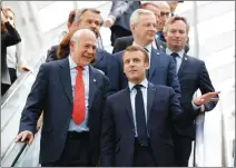  ?? Associated Press photo ?? French President Emmanuel Macron, right, and Organizati­on for Economic Co-operation and Developmen­t (OECD) Secretary-General Angel Gurria arrive at the OECD ministeria­l council meeting Wednesday in Paris, France.