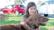  ?? CINDY CHOI/STAFF PHOTOGRAPH­ER ?? Angelina Montello, 8, meets her family’s new dog, a golden retriever, Maya, who arrived from Puerto Rico as the 100th dog rescued from Golden Rescue South Florida.