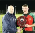  ??  ?? St Kevin’s captain Robbie Miley accepts the cup.