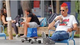  ?? (AFP) ?? A man drinks coffee on a terrace after authoritie­s announced that face masks for COVID-19 prevention were no longer needed outside, in the coastal city of Tel Aviv on Sunday