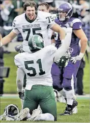  ?? M. Spencer Green Associated Press ?? PETE CLIFFORD (75) and Michigan State erased a 35-point deficit to beat Northweste­rn in 2006.