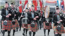  ?? PAUL FORSYTH NIAGARA THIS WEEK ?? City of Thorold Pipe Band pipe major Gary Cooper, left, and other band members lead the parade to the Thorold Remembranc­e Day ceremony.