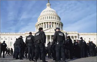  ?? Evan Vucci / Associated Press ?? A large group of police arrive at the Capitol on Thursday.