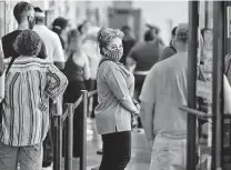  ?? Robin Jerstad / Contributo­r file photo ?? Election workers are tested in November 2020. Officials say the pandemic remains a concern in the upcoming March 1 primary.