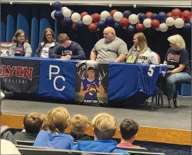  ?? Tara Morgan/Special to the News-Times ?? Willeford signs: Parkers Chapel standout Payton Willeford finalizes his college plans by signing with Lyon College on Thursday. Willeford had eight touchdowns rushing and receiving combined for the Trojans in his senior season.