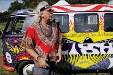  ?? SETH WENIG - THE ASSOCIATED PRESS ?? In this Thursday, Aug. 15 photo, a man who calls himself “Run-A-Way Bill” stands in front of a Volkswagen bus while waiting for the gates to open at a Woodstock 50th anniversar­y event in Bethel, N.Y.