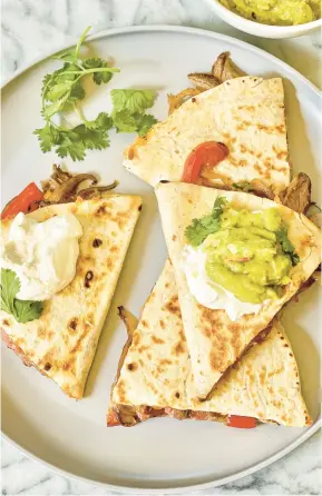  ?? KELLI FOSTER/THEKITCHN.COM ?? These loaded steak quesadilla­s are packed with cumin-rubbed steak and veggies.