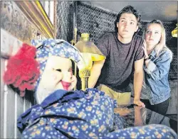  ?? SUBMITTED PHOTO ?? Tyson Gillis of Fredericto­n, P.E.I., left, and Bronwyn Bridges of Summerside carefully check out the spooky lobby of the Route 6 Motel. The Cavendish attraction will be open Thursday to Sunday this week and Friday to Sunday next week for the Halloween...