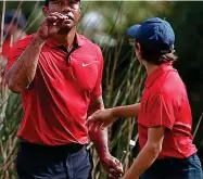  ?? AP ?? Having a ball: Tiger Woods and son Charlie on their way to a remarkable 57