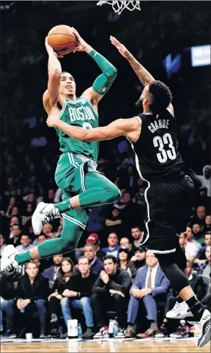  ?? AP PHOTO ?? Boston Celtics Jayson Tatum, left, takes a shot over Brooklyn Nets’ Allen Crabbe during Tuesday’s NBA game in New York.