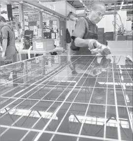  ?? Matthias Rietschel Getty Images ?? GERMAN firm SolarWorld’s Oregon-based subsidiary is one of two U.S. panel makers urging import tariffs. But most of the solar industry opposes the levies.