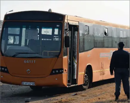  ?? PICTURES: MASI LOSI ?? BULLET-RIDDLED: A police officer inspects the Putco bus which was attacked by unknown gunman in Mamelodi yesterday morning.