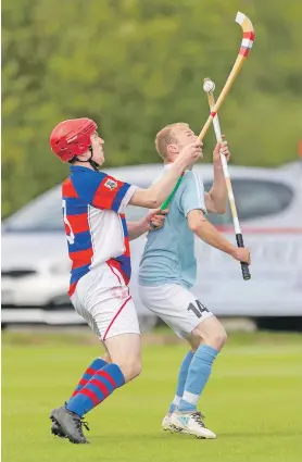  ?? Photograph: Neil Paterson. ?? Kingussie’s Calum Grant keeps a close eye on Caberfeidh’s Kevin Bartlett during last Saturday’s Camanchd Cup second round replay.