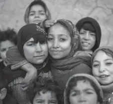  ?? SHAH MARAI/AFP/GETTY IMAGES ?? Internatio­nal aid programs have helped females across the world, including these Afghan women and girls who have been displaced by violence.