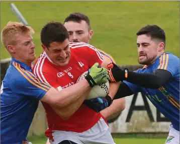  ??  ?? John Manley and Eddie Doyle join forces to stop Louth’s Robert Brodigan.