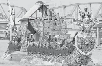  ?? File photo — Reuters ?? Thai oarsmen row a royal barge during the Royal Barge Procession on the Chao Phraya River in Bangkok.