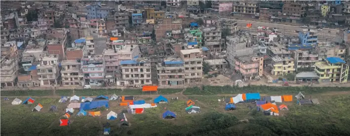  ??  ?? The parks of Kathmandu, Nepal’s capital, are full of tarpaulins that shelter people who are too afraid to go home or have no home to go to after the earthquake­s this spring.