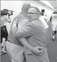  ?? Democrat-Gazette file photo ?? Arkansas Athletic Director Jeff Long congratula­tes a member of the UA football staff after the Razorbacks’ victory over TCU at Fort Worth in 2016. Long was fired Wednesday.