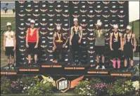  ?? Submitted photo ?? ALL-AMERICANS: Lake Hamilton rising senior Haze Farmer, center, placed second Sunday in the pole vault at the 2018 New Balance Outdoor National Track and Field Meet at BB&amp;T Stadium in Greensboro, N.C.