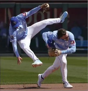  ?? ED ZURGA — GETTY IMAGES/TNS ?? Kansas City's Nick Loftin, left, leaps over teammate Bobby Witt Jr. as Witt Jr. fields a ball hit by Houston's Victor Caratini in the fourth inning of Thursday's game. The Royals won 13-3.