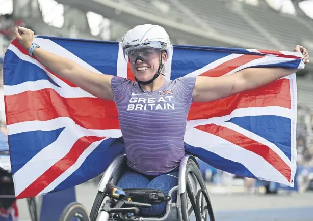  ?? ?? Hannah Cockroft celebrates victory in the women’s 100m T34 final at the Para Athletics World Championsh­ips in Paris. Pic: Matthias Hangst/Getty Images