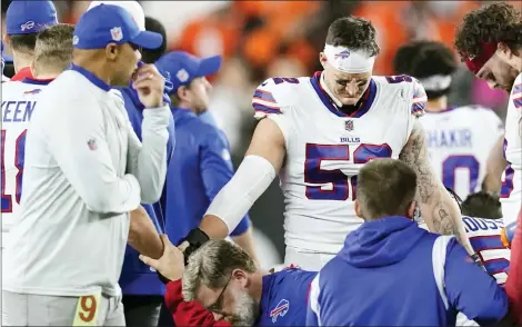  ?? JOSHUA A. BICKEL-ASSOCIATED PRESS FILE ?? Buffalo Bills players and staff pray for Buffalo Bills’ Damar Hamlin during the first half of an NFL football game against the Cincinnati Bengals, Monday, Jan. 2 in Cincinnati.