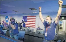  ?? BILL INGALLS/NASA ?? Members of NASA’s Perseveran­ce team in Pasadena, California, jump up and cheer in triumph — and relief — Thursday after receiving word the rover successful­ly touched down on Mars. The rover is equipped with 25 cameras.