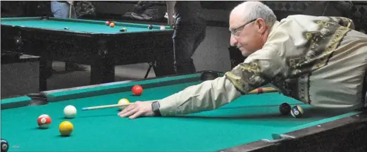  ?? Photos by Matthew Liebenberg ?? Mitch Minken, the City of Swift Current's general manager of infrastruc­ture and operations, gets ready to make a shot during a game Jan. 16.