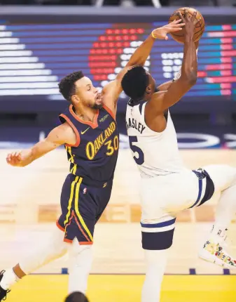  ?? Scott Strazzante / The Chronicle ?? The Warriors’ Stephen Curry defends against the Timberwolv­es’ Malik Beasley during a game in January. Curry is a big reason the Warriors boast the NBA’s fourthbest defense.