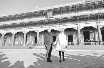  ?? — Reuters photos ?? President Macron and his wife Brigitte pose during their visit to the Forbidden City, in Beijing, China, last Tuesday. (Below) Macron and Brigitte visit the Great Mosque of Xian in the city of Xian, Shaanxi province, China, recently.