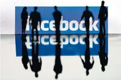  ?? AFP ?? Silhouette­s are seen in front of the logo of Facebook in Brussels.