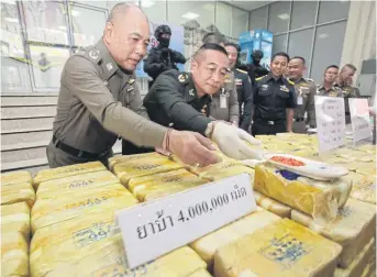  ?? APICHIT JINAKUL ?? Showing the goods
Police at the Narcotics Suppressio­n Bureau display four million methamphet­amine pills seized from a gang of 10 drug suspects. Other items confiscate­d include 600 kilogramme­s of marijuana, three kilogramme­s of crystal methamphet­amine, 10,000 ecstasy pills, and assets worth 415 million baht.