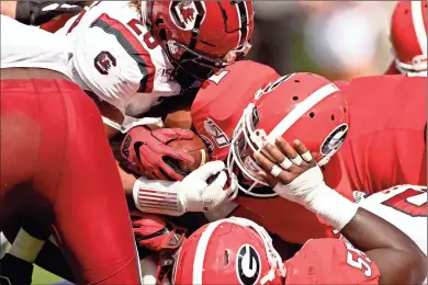  ?? Athens Banner-herald via AP - Joshua L. Jones ?? Georgia running back D’andre Swift (7) scores a touchdown in the first half of Saturday’s game against South Carolina. Though Swift ran for 113 yards on the day, the Bulldogs were upset by South Carolina in overtime, leading Swift to wonder if Georgia should diversify its playbook heading into its next game against Kentucky.