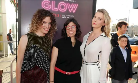  ?? ERIC CHARBONNEA­U/NETFLIX ?? Liz Flahive and Carly Mensch, left, co-creators of Glow, with star Betty Gilpin at the show’s Los Angeles premiere. The pair are also playwright­s and have fellow playwright­s in their writers room.