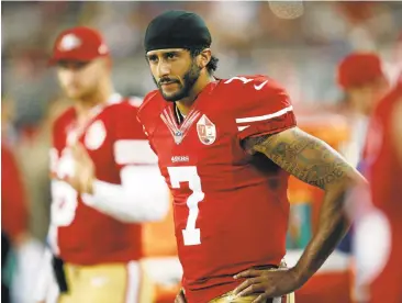  ?? JIM GENSHEIMER/STAFF ?? 49ers quarterbac­k Colin Kaepernick has caused a firestorm by not standing during the national anthem before Friday’s game against Green Bay in protest over the nation’s treatment of people of color.