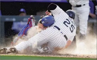  ?? David Zalubowski Associated Press ?? C.J. CRON of the Rockies beats a tag attempt in the seventh inning at home by Dodgers catcher Austin Barnes, who hurt his right hand on the play and had to leave the game in Denver.