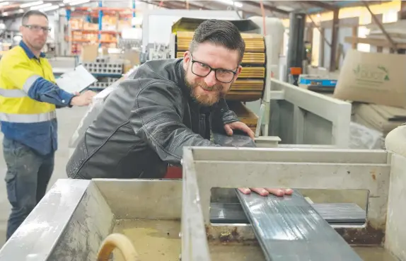  ?? Picture: PETER RISTEVSKI ?? ECO-FRIENDLY: Think Fencing’s Jack Fitzgerald at the manufactur­ing plant in Portarling­ton where his company is developing a new decking product (below) that uses recycled PVC products such as used store loyalty cards.