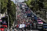  ?? REBECCA BLACKWELL / ASSOCIATED PRESS ?? A group of Central American migrants march toward the office of the United Nations’ humans rights body in Mexico City on Thursday.