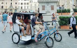  ??  ?? Firenze L’invasione di risciò e caddy trasporta-turisti nel centro storico