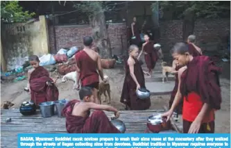  ??  ?? BAGAN, Myanmar: Buddhist monk novices prepare to wash their alms vases at the monastery after they walked through the streets of Bagan collecting alms from devotees. Buddhist tradition in Myanmar requires everyone to spend some time in a monastery or...