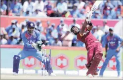  ?? AP ?? Dwayne Bravo is bowled by Amit Mishra as MS Dhoni looks on.