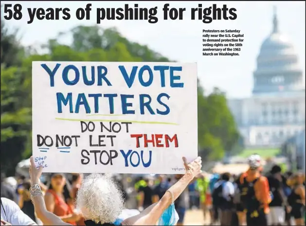  ??  ?? Protesters on Saturday rally near the U.S. Capitol to demand protection for voting rights on the 58th anniversar­y of the 1963 March on Washington.