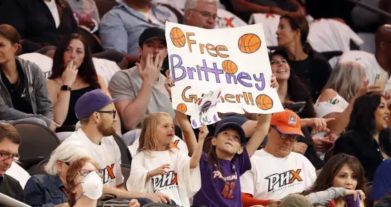 ?? Photos by Chris Coduto, Getty Images ?? A young fan holds a sign honoring Brittney Griner during the game between the Phoenix Mercury and the Las Vegas Aces at Footprint Center on Friday night in Phoenix.