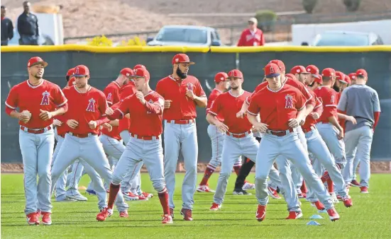  ?? MATT KARTOZIAN/USA TODAY SPORTS ?? The Angels stretch and warm up at Tempe Diablo Stadium during the first week of camp.