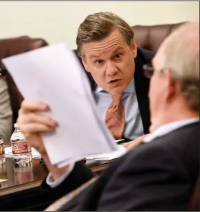  ?? Democrat-Gazette/Staci Vandagriff) ?? Sen. Scott Flippo (left), R-Bull Shoals, leans over to speak with Sen. Terry Rice, R-Waldron, during the Senate Committee on City, County, and Local Affairs on Thursday at the state Capitol. (Arkansas