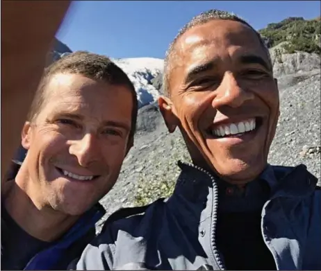  ??  ?? Ooops: President Obama puts his finger over the lens as he takes a selfie with Bear Grylls in Alaska