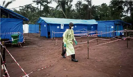 ?? — AFP ?? Deadly virus: A 2017 filepic of a health worker at an Ebola quarantine camp in Muma, Congo.